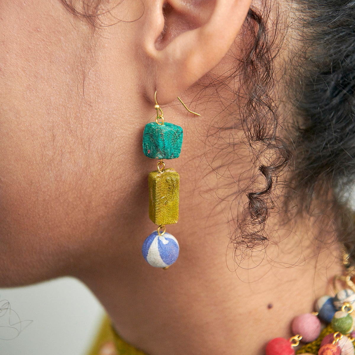 A woman wears the Kantha Linear Shapes Earrings.