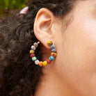 A Kantha Open Hoop Post adorns an ear.