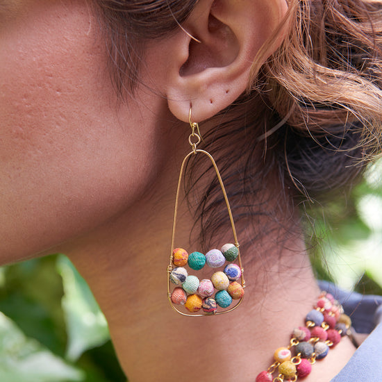 A woman wears Embedded Kantha Earrings.