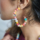 A Kantha Rectangular Hoop adorns an ear.