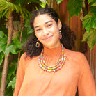 A model wears the Kantha Dangling Teardrop Earrings.