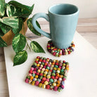 A blue mug sits on top of a Sari Home Circle Coaster.