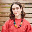 A model wears the rainbow-hued Galaxy Graduated Necklace and matching earrings.
