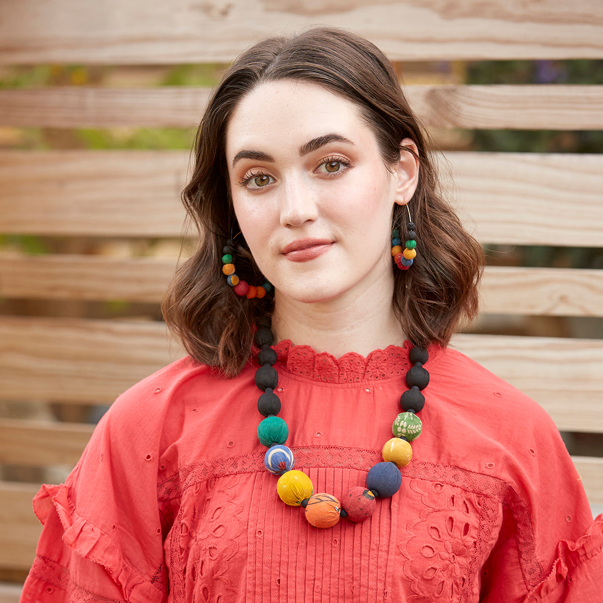 Load image into Gallery viewer, A model wears the rainbow-hued Galaxy Graduated Necklace and matching earrings.
