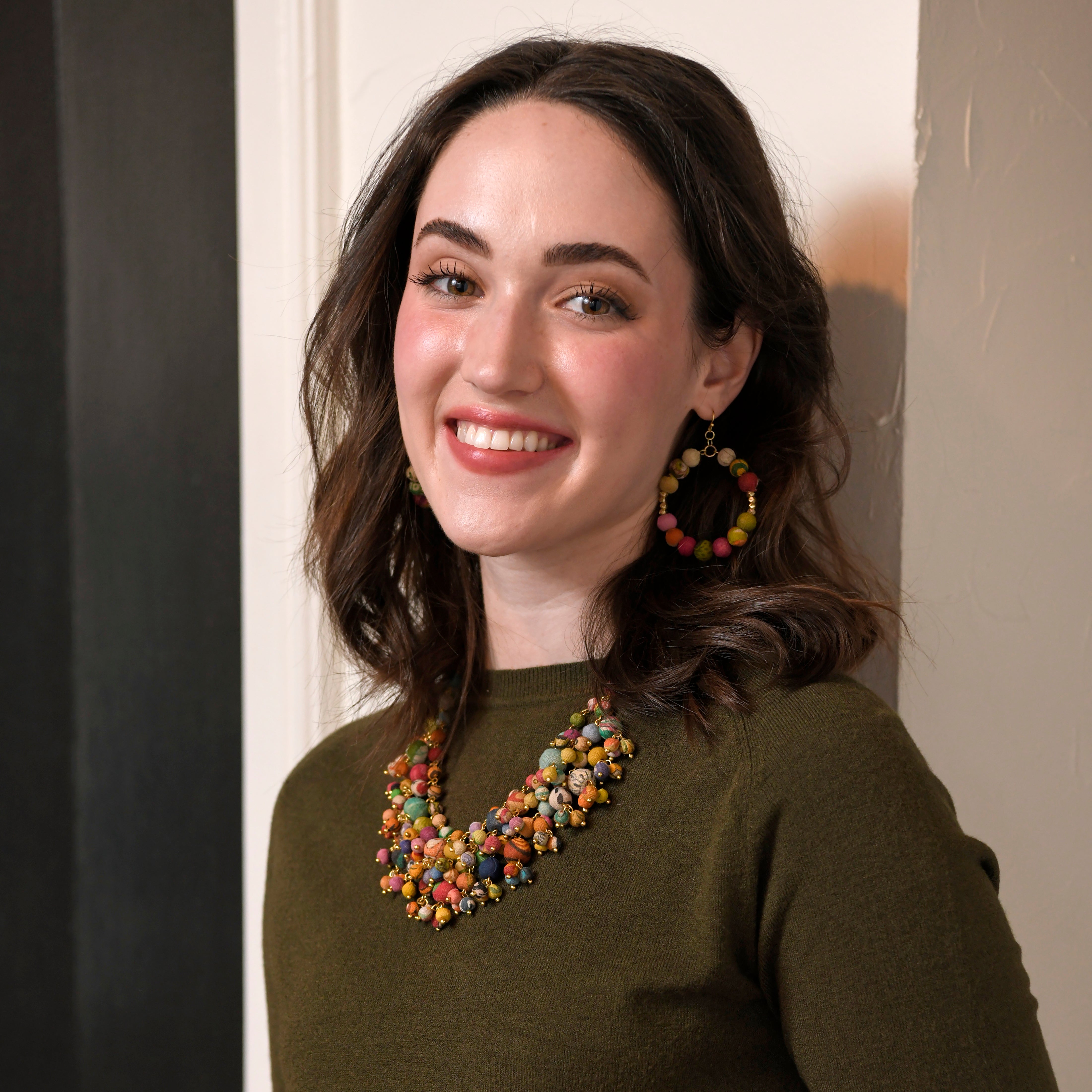 A model laughs while posing with the Kantha Khalani Necklace.