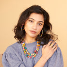 A woman wears the Kantha Tresora Necklace.