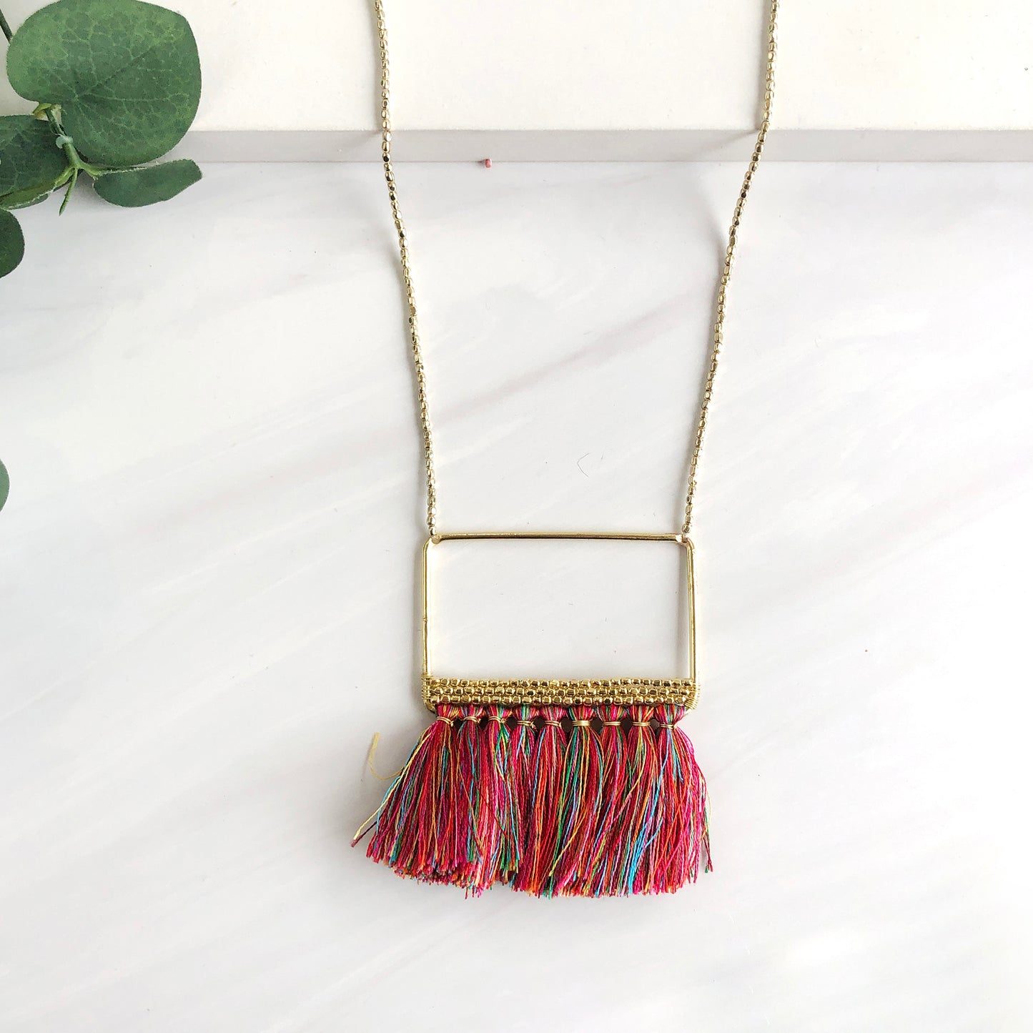 A close up of the tassels on a necklace.