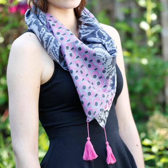 A woman models the Ikat Patchwork Scarf in Gray.