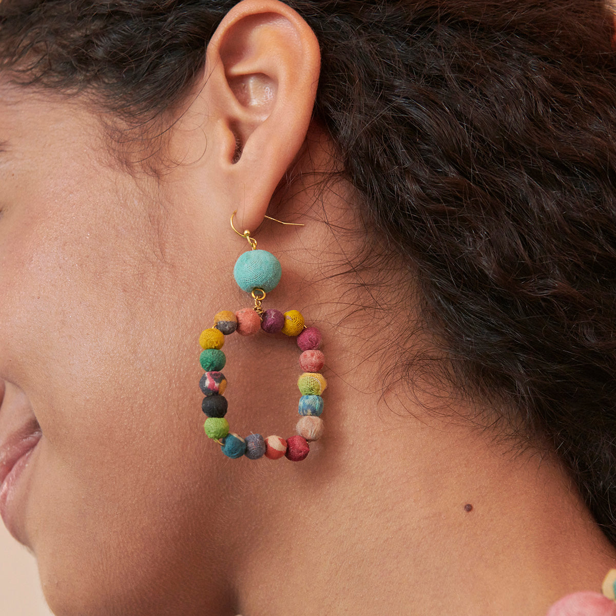 A model wears the Kantha Dangling Square Earrings.