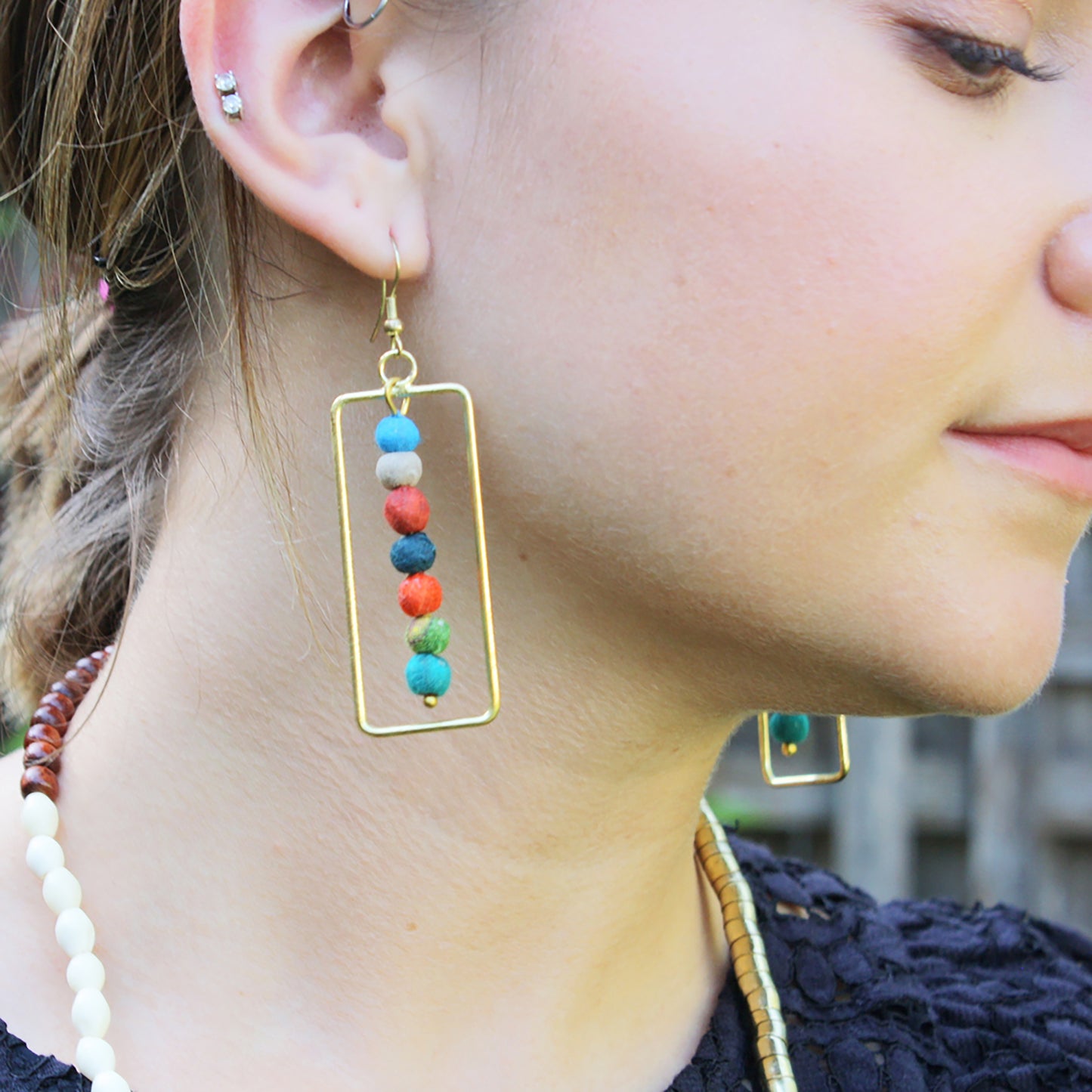 Load image into Gallery viewer, A woman models the Framed Kantha Earrings.
